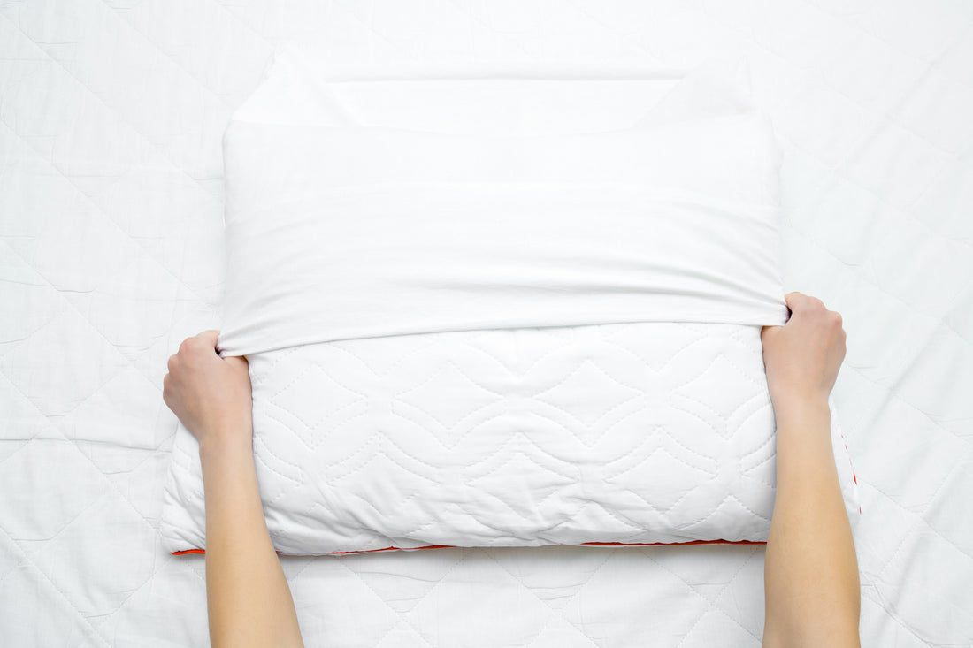 woman-changing-a-pillowcase-with-a-freshly-cleaned-one
