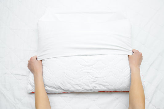 woman-changing-a-pillowcase-with-a-freshly-cleaned-one
